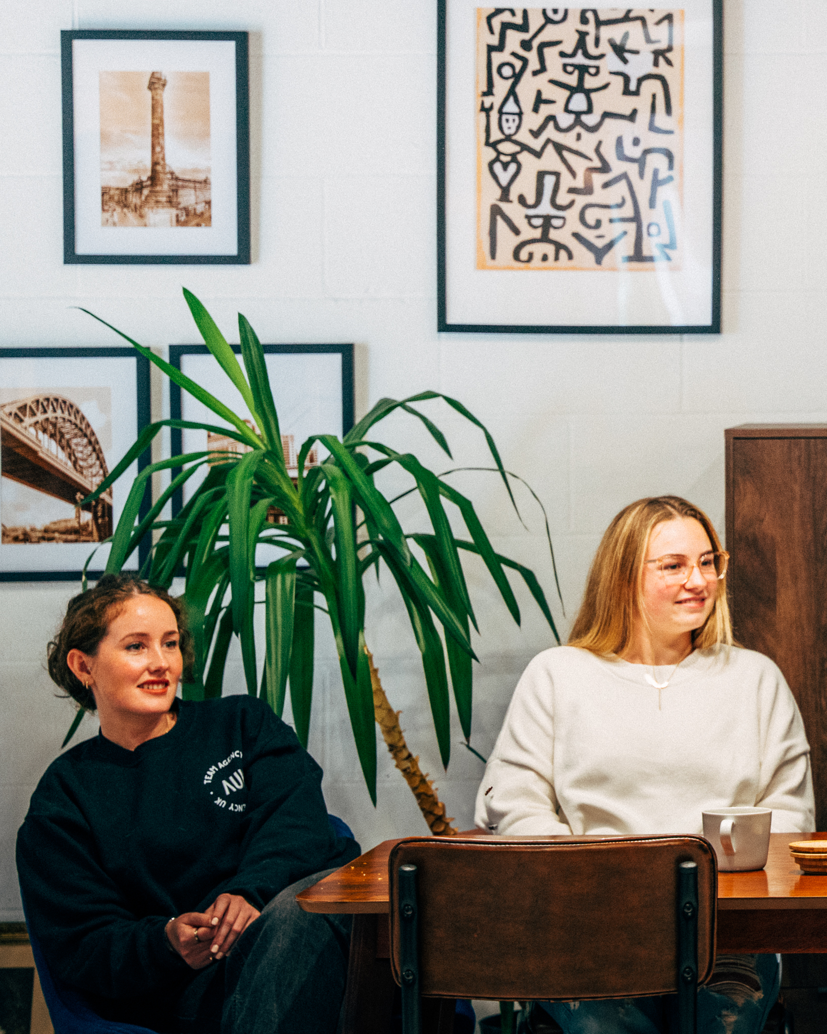 Image of two AUK employees watching a presentation looking engaged