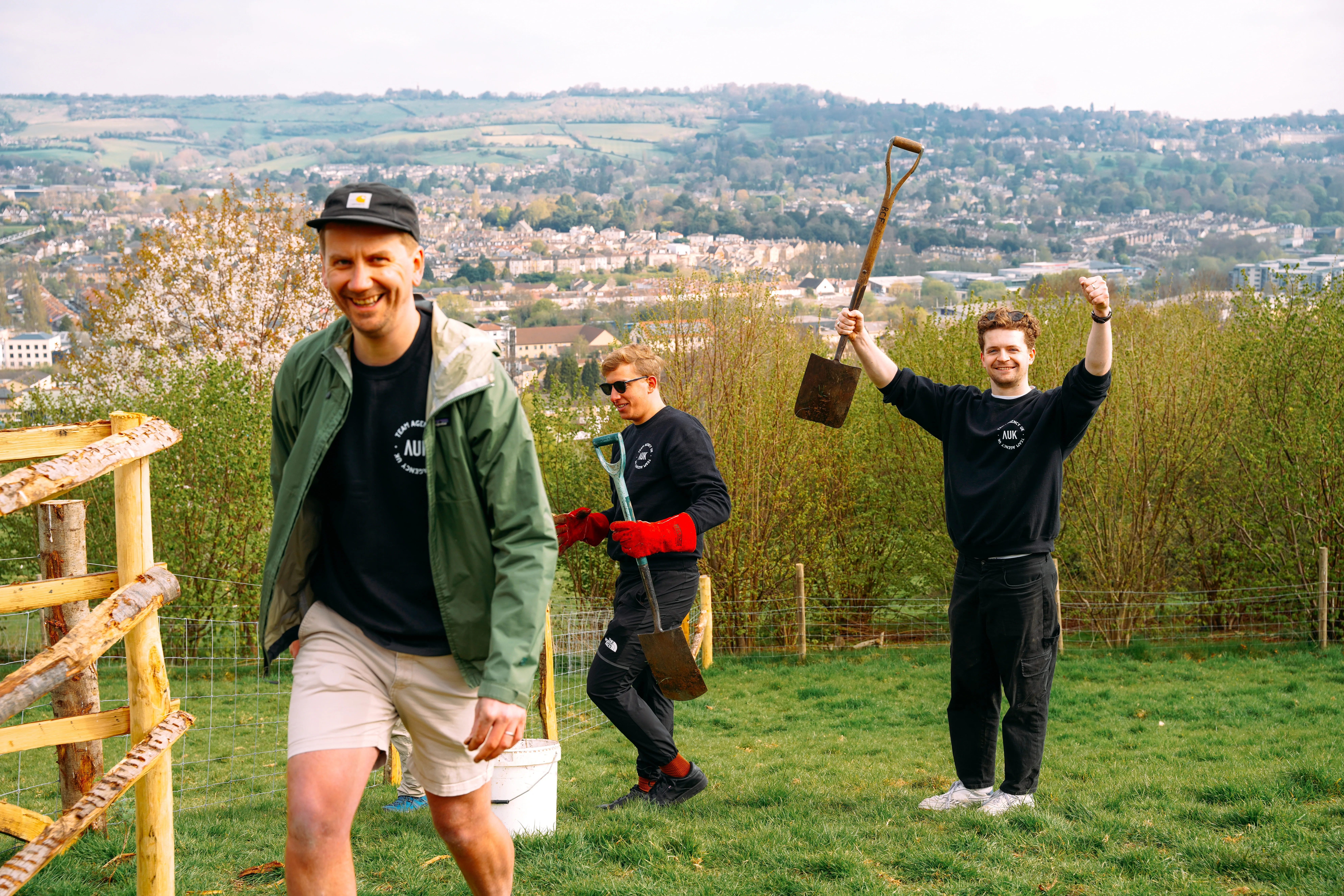 AgencyUK team volunteering outdoors with spades