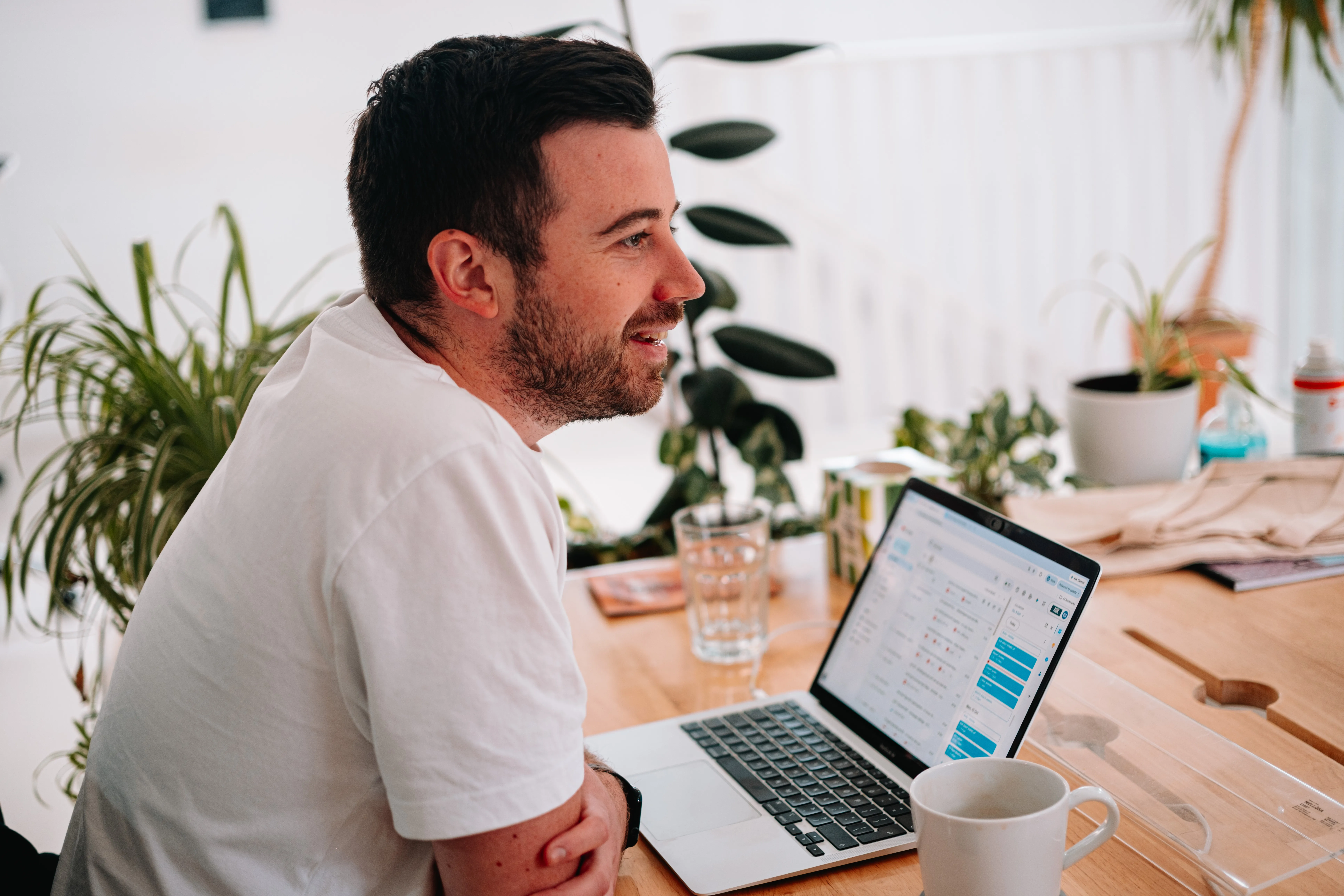 AgencyUK team member smiling while working on a laptop