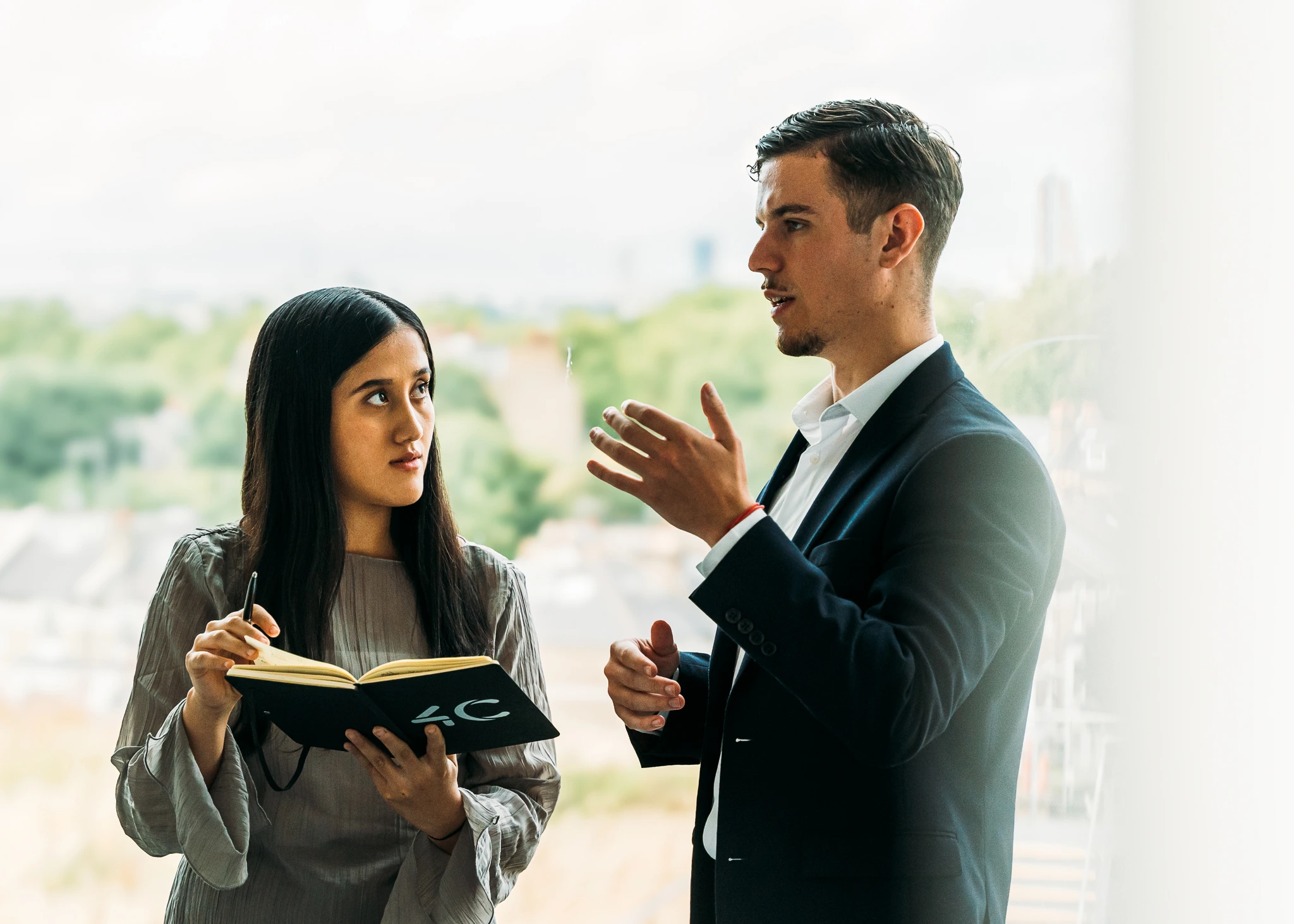 Two colleagues talking in the 4C Associates office