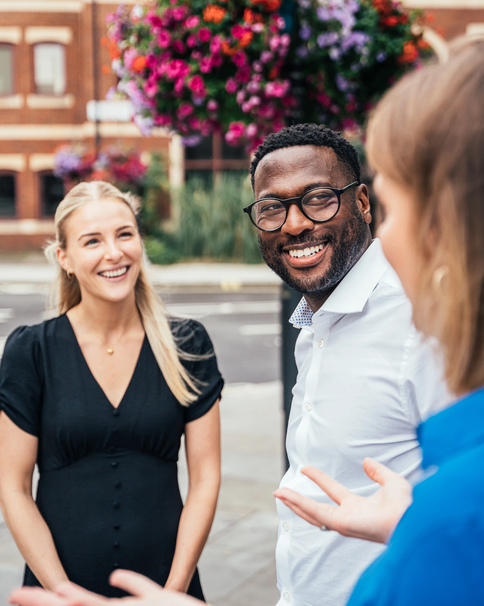 Colleagues chatting outdoors on a street for 4C Associates