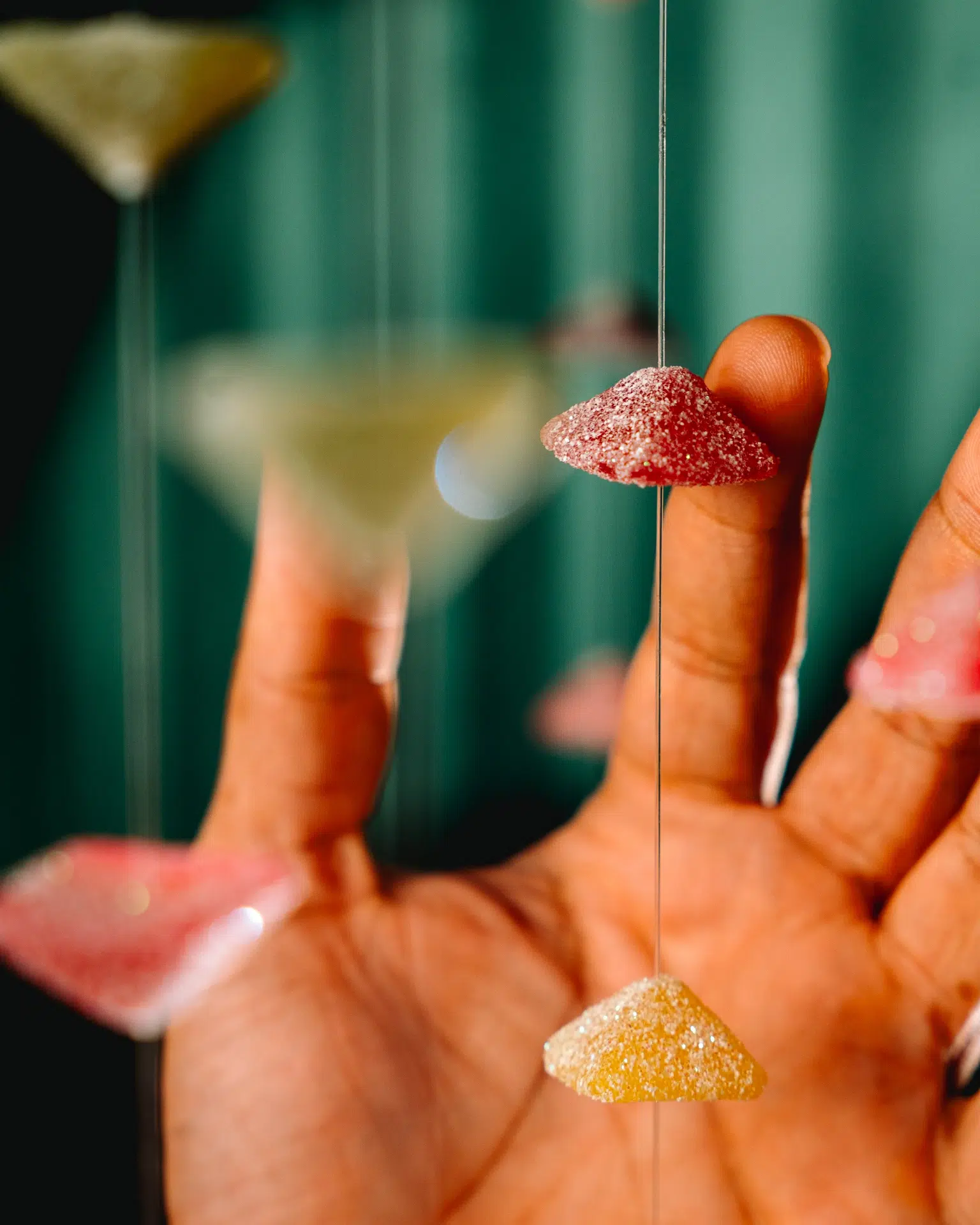Hand holding colourful gummy sweets