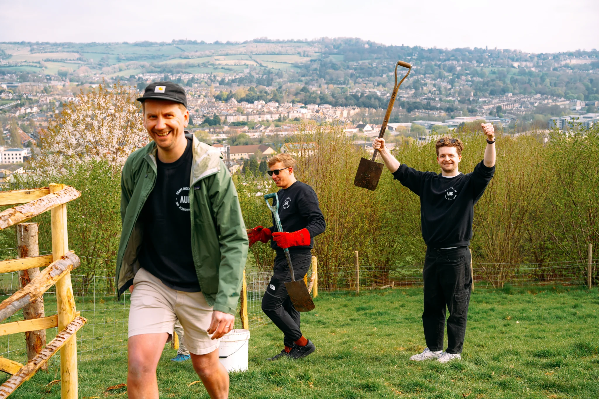 AgencyUK team volunteering outdoors with spades