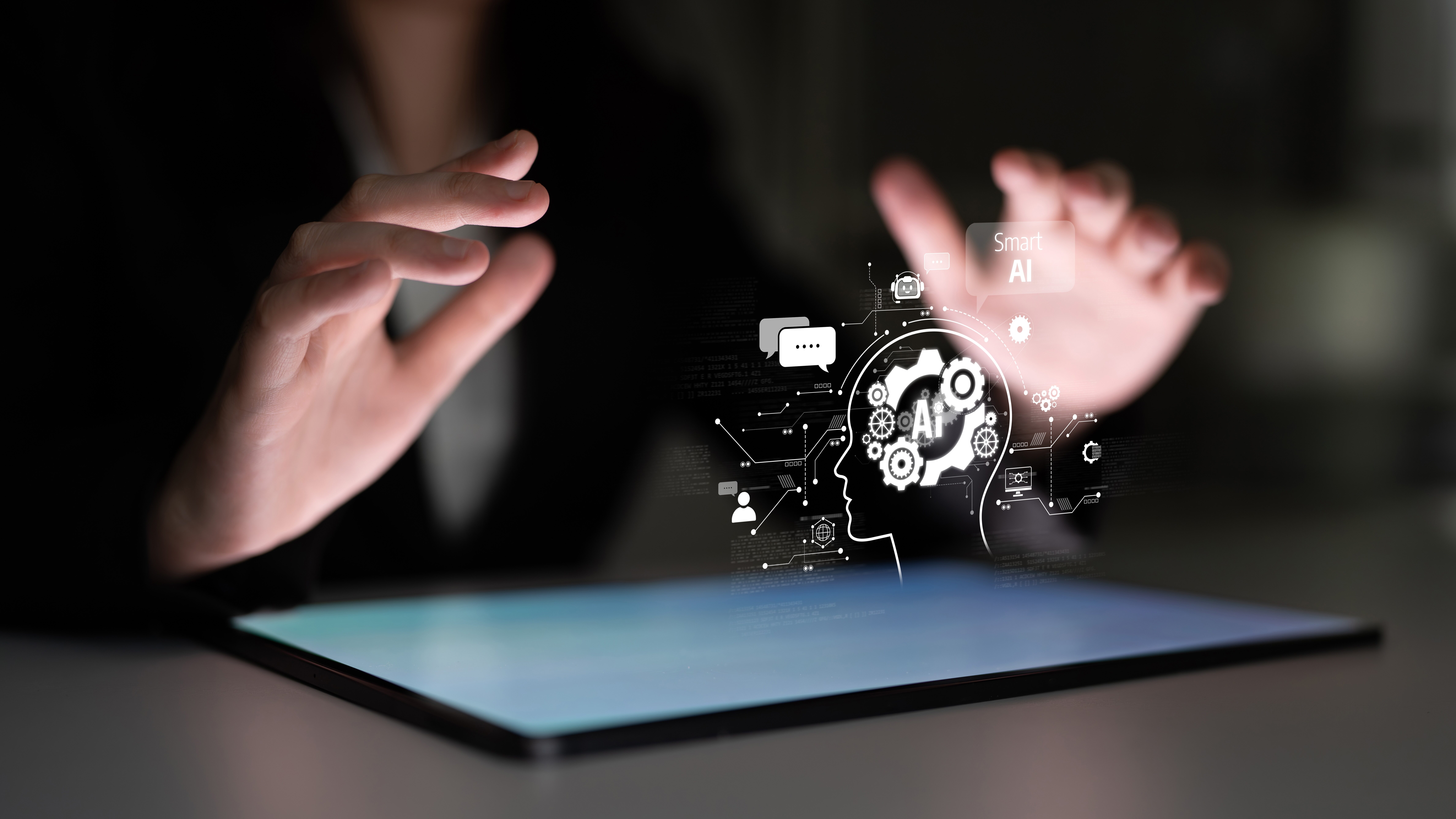 Hands over a tablet projecting an AI hologram