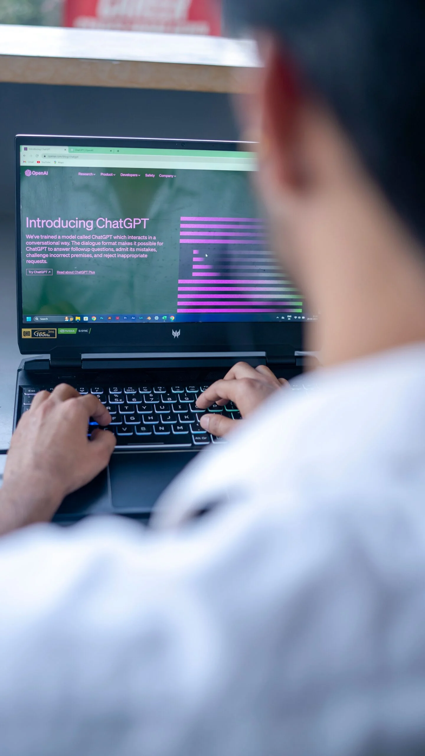 Person using a laptop showing ChatGPT