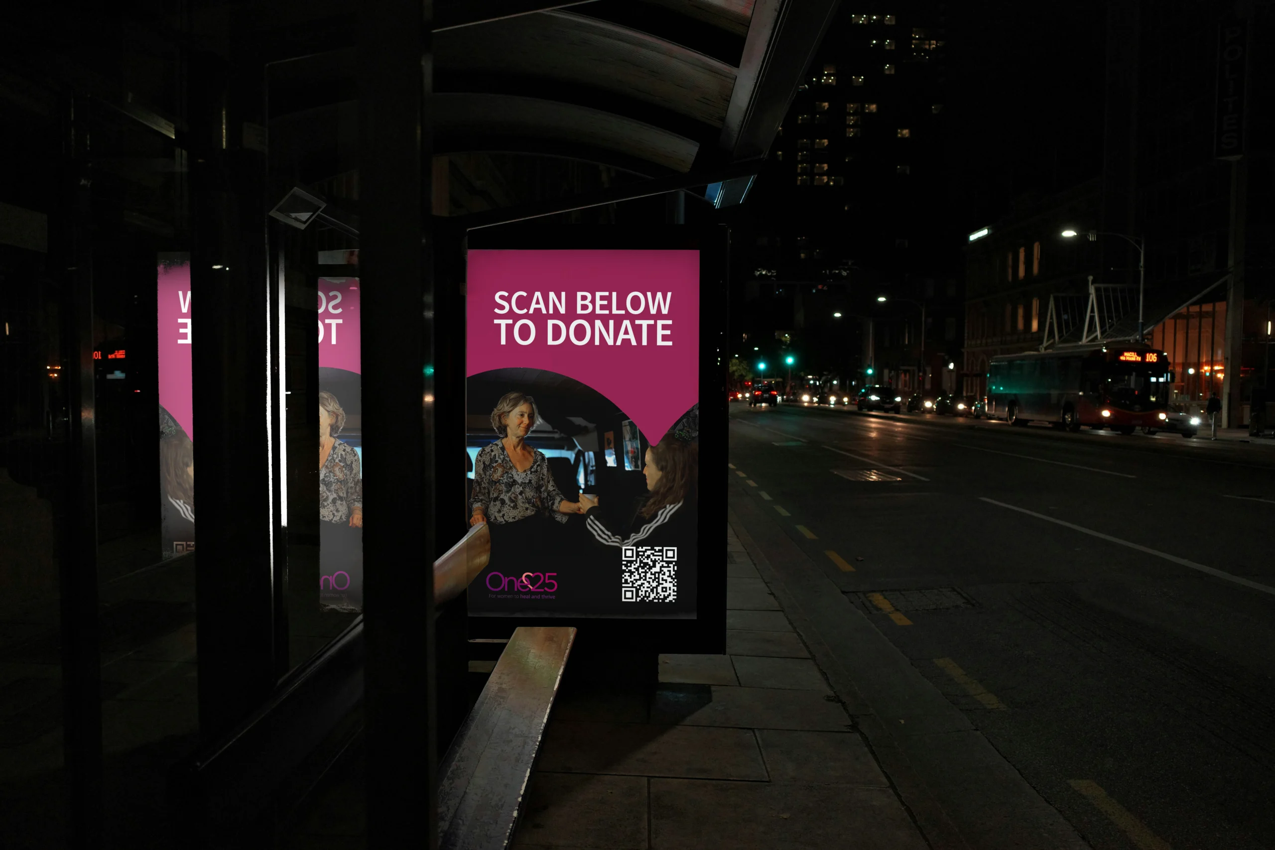 Charity donation advert on a bus shelter screen at night