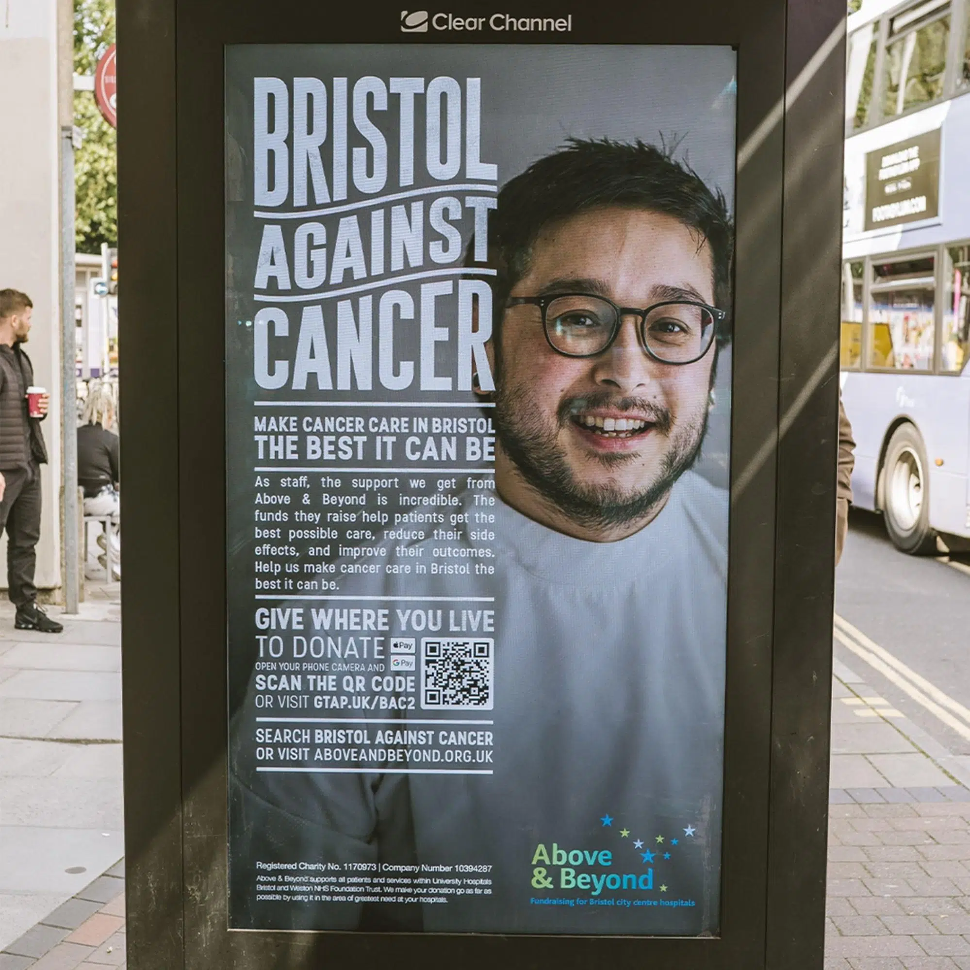 Bristol Against Cancer street poster featuring a smiling man