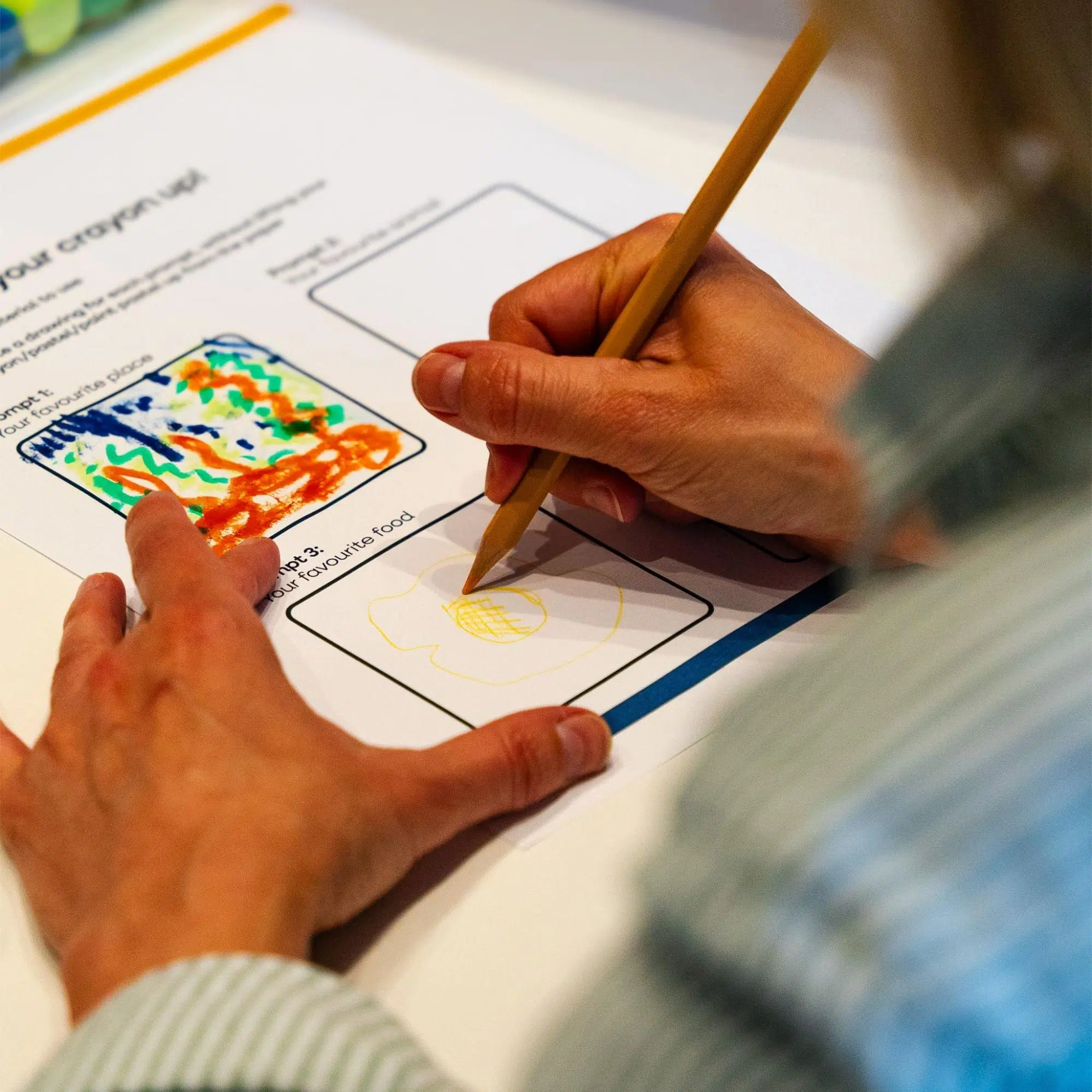 Hand drawing a colourful illustration with a pencil