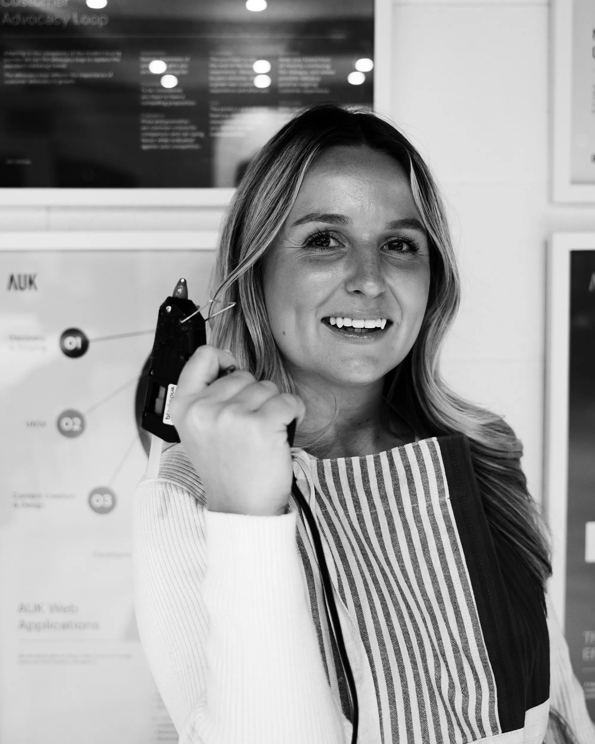 Black and white portrait of a smiling AgencyUK team member