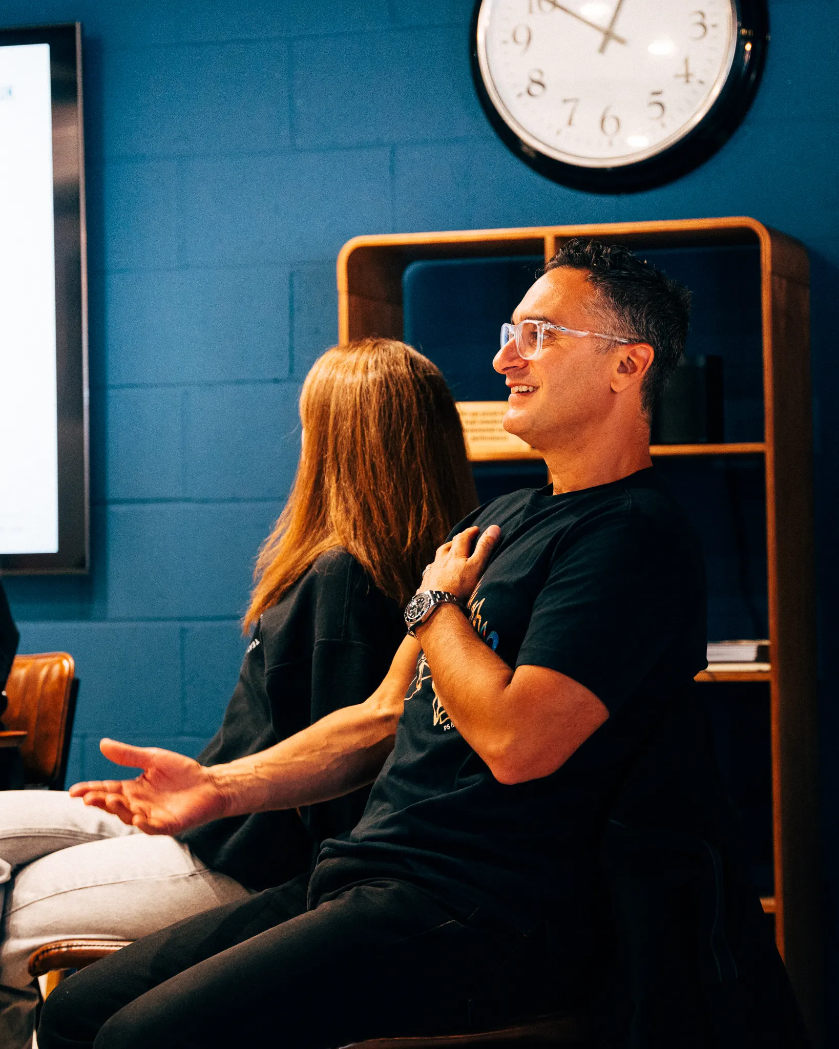 AgencyUK colleagues chatting on a sofa in the studio