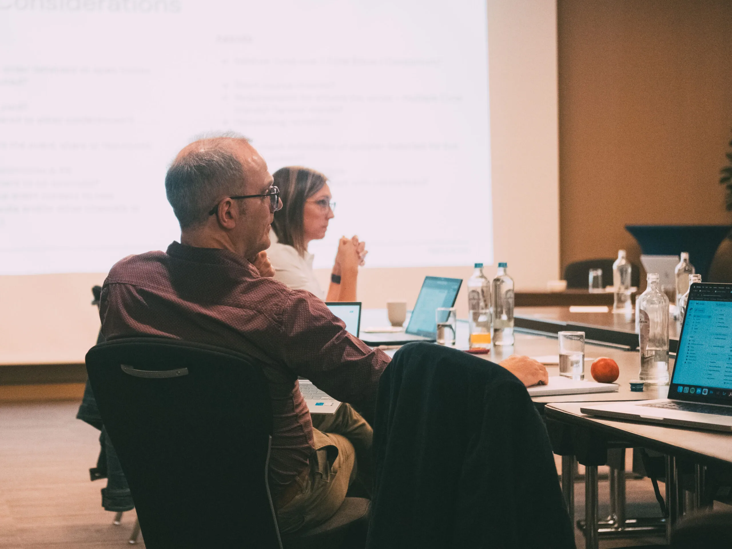 AgencyUK team in a workshop around a meeting room table